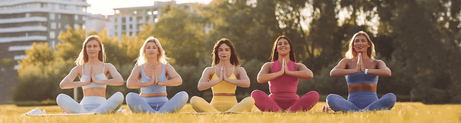 Group of women doing yoga in a park