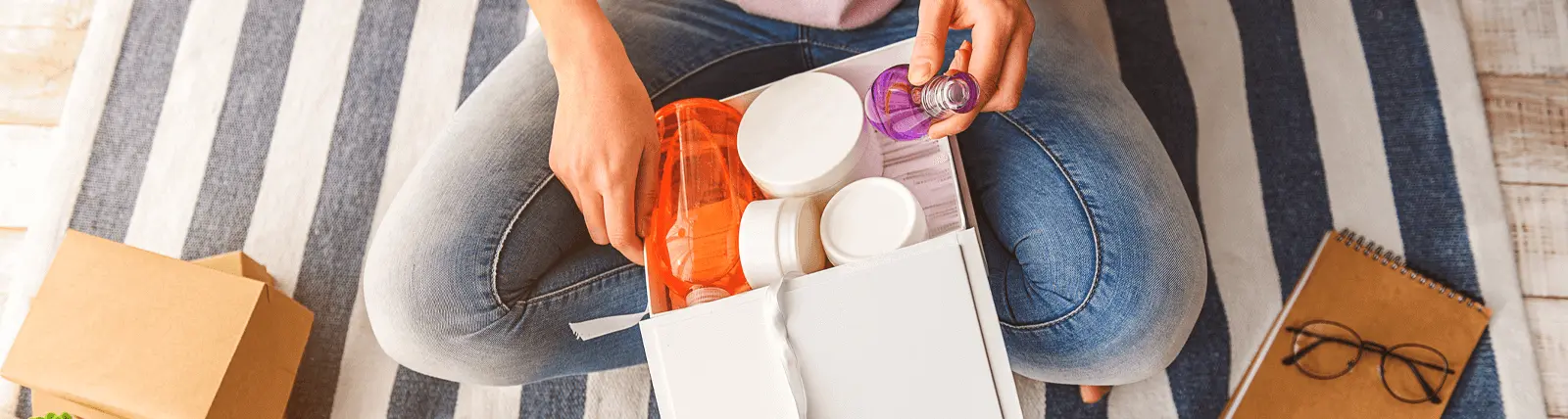 Person opening a package containing beauty products