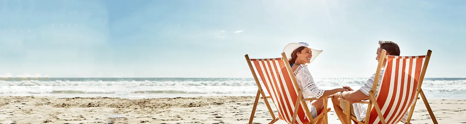 Two people sitting on the beach