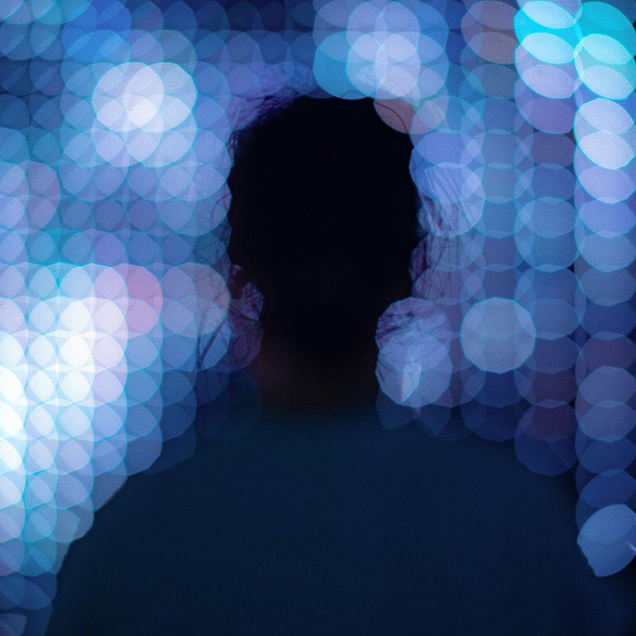 Silhouette of a person on a tech background