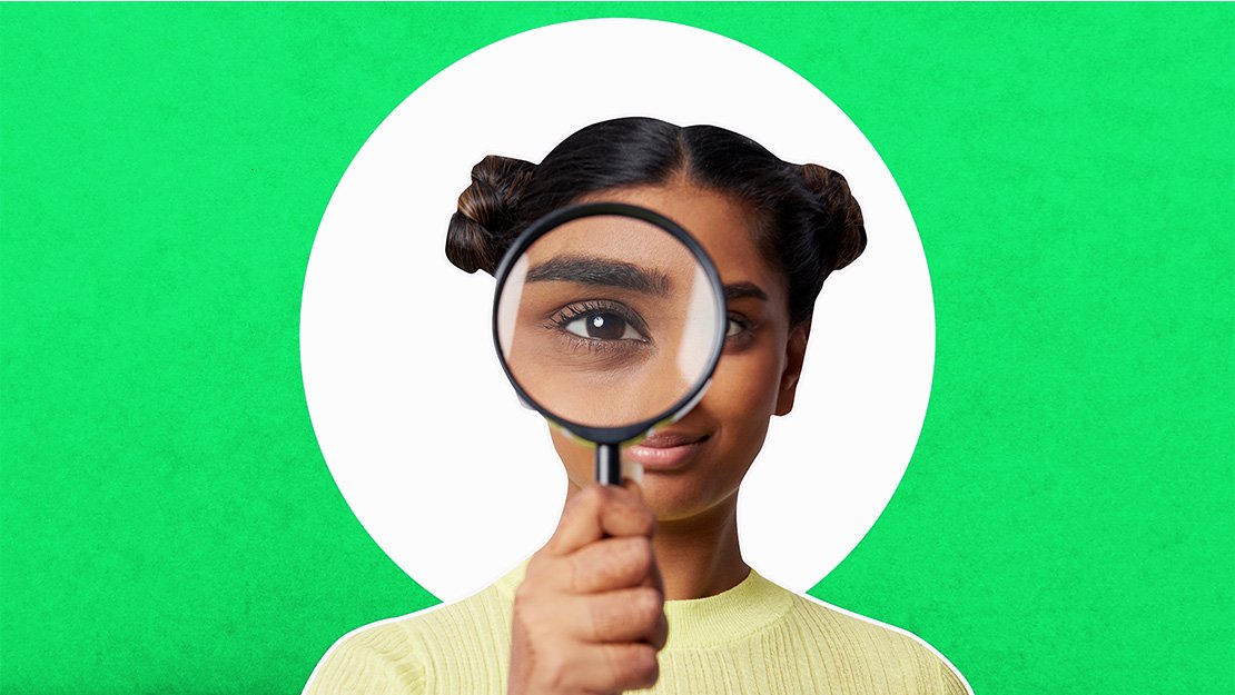 Person looking through a magnifying glass
