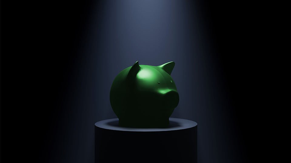Green piggy bank on a pedestal