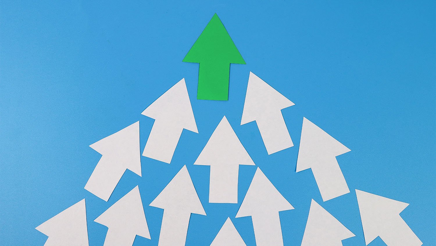 White arrows pointing up with one green arrow at the top