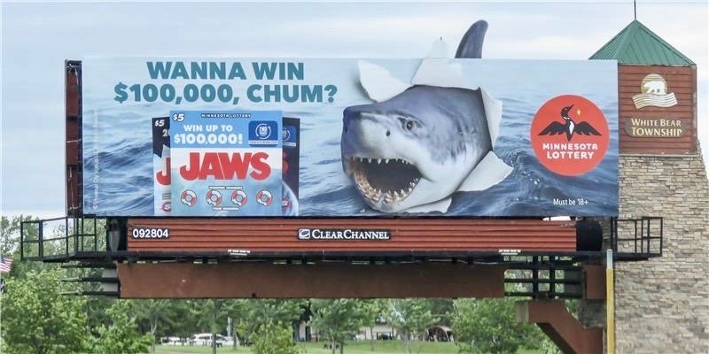 A Minnesota State Lottery billboard that showcases the film Jaws by Steven Spielberg