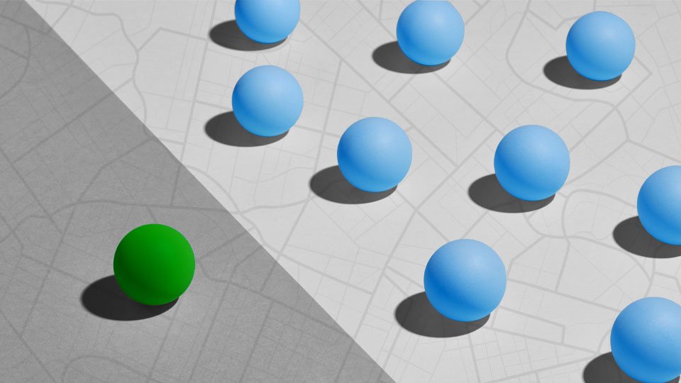 One green globe set apart from many blue globes